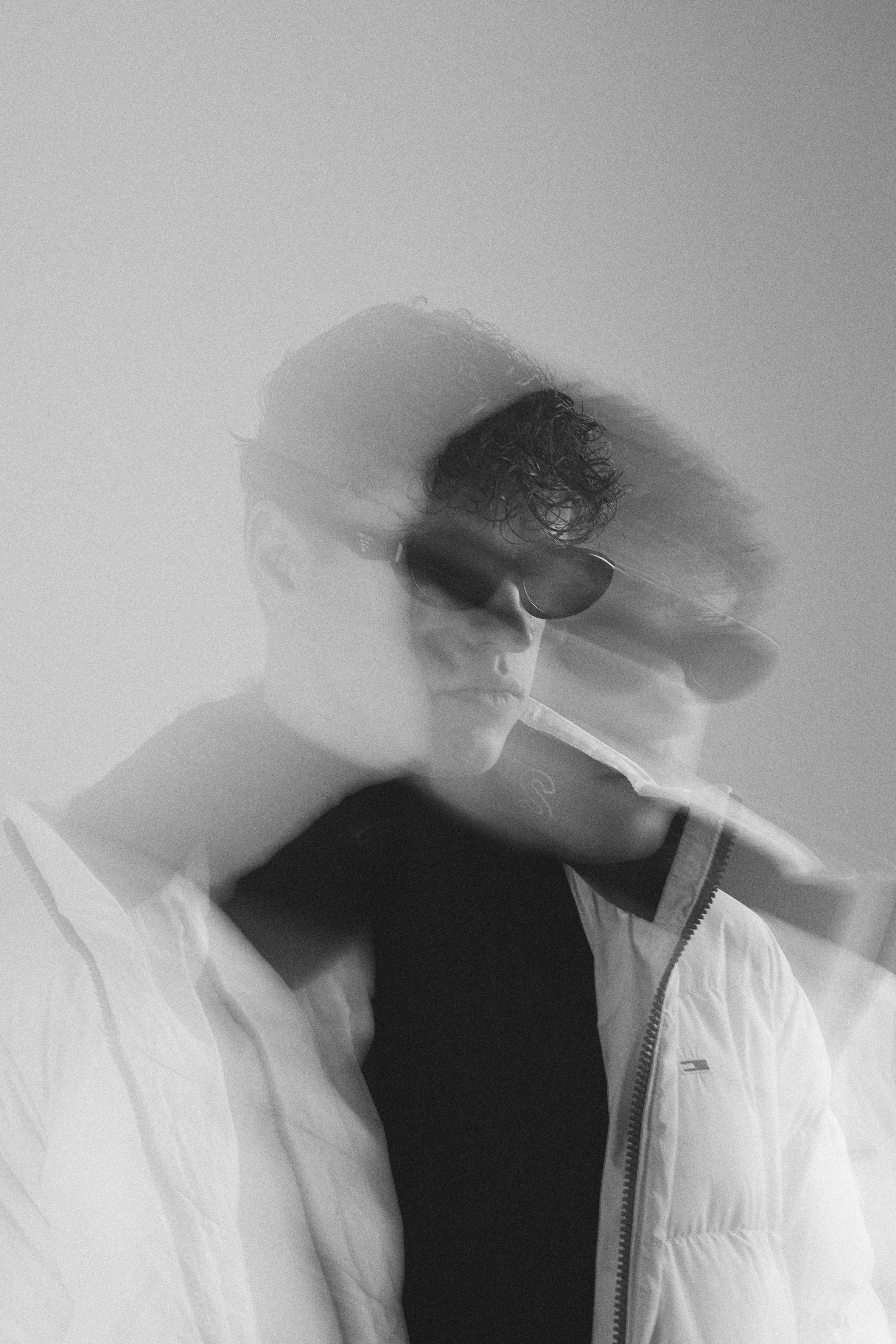 Motion blur portrait in white puffer jacket and sunglasses